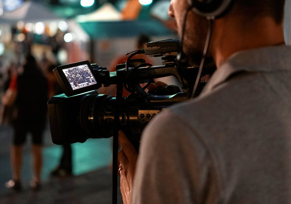 professional-cameraman-recording-poeple-watching-football-public-place-night professional-cameraman-recording-poeple-watching-football-public-place-night